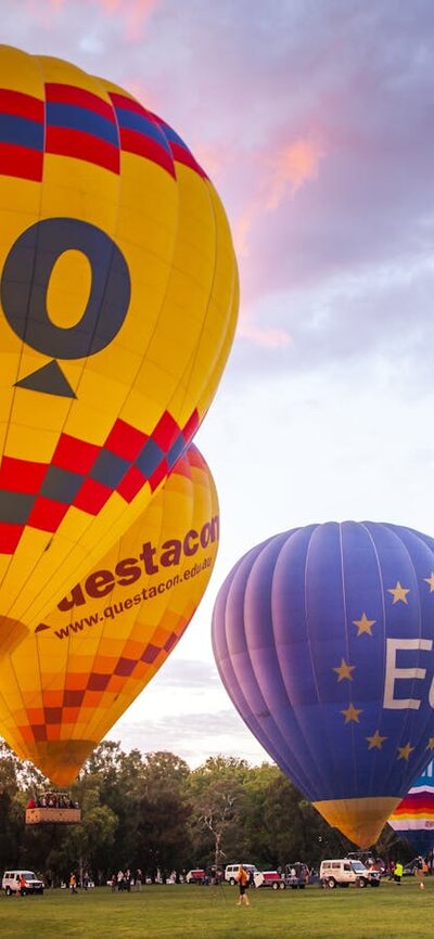 Balloons rising into the sky as dawn breaks