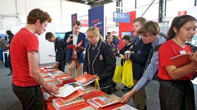 Free entry to students and adults who are seeking information aout careers, jobs or courses. Student at desk at Canberra CareersXpo seeking information about courses and careers.