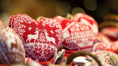 Heart shaped Christmas ornaments on display at a market