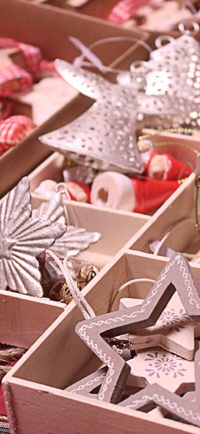 Christmas ornaments in open boxes sitting on a table an a market