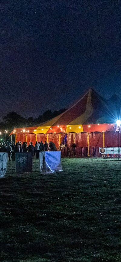 The May Wirth Big Top at night, at the Canberra Circus Festival A queue of people outside a bigtop tent. Nimble by Rooke is great circus for the whole family