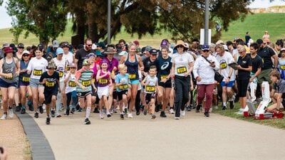 Group of people running and participating in the fun run