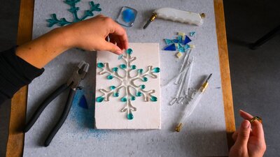 Fire and Ice: Kilnformed Snowflake school holidayprogram Hand arranging glass for kilnformed snow flake