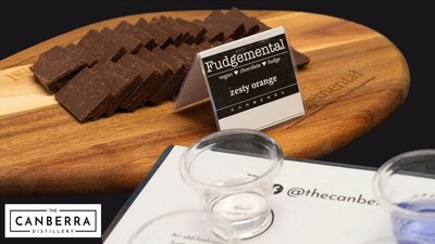 fudge on a wooden platter and tasting glasses of gin