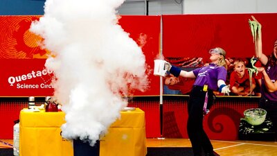 A woman demonstrating with liquid nitrogen at a Pop-up Science Centre