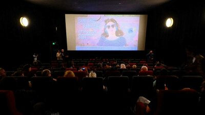 CSFF screening with audience watching Screening of a CSFF Film in a Cinema with screen in the background and the audience in foreground