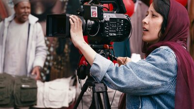 No Good Men, screening Sat, Oct 24, 2026 Woman behind a large film camera in action