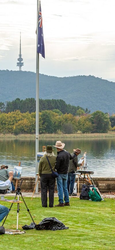 Artists painting on the lawn of Government House overlooking Lake Burley Griffin