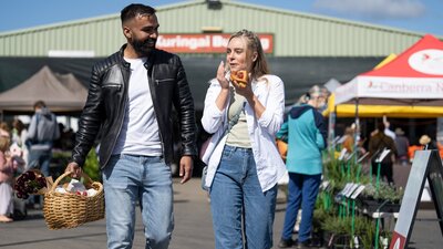 shoppers enjoying food and shopping at the farmers market