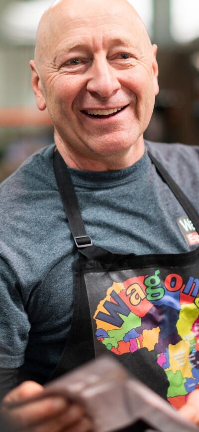 Smiling face of producer Wagonga Coffee at farmers market in Canberra