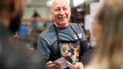 Meet the producers at Capital Region Farmers Market Smiling face of producer Wagonga Coffee at farmers market in Canberra
