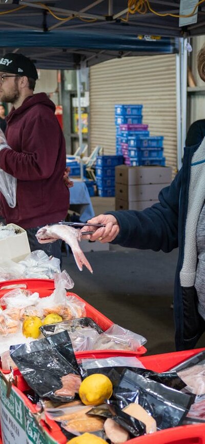 Fresh seafood at Capital Region Farmers Market shoppers selecting fresh seafood from local farmers market in Canberra
