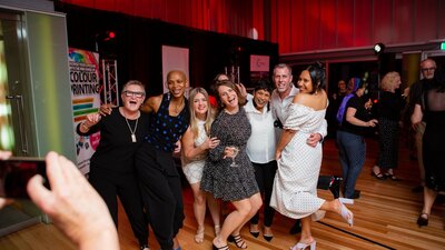 Group of people at an event looking happy getting their photo taken