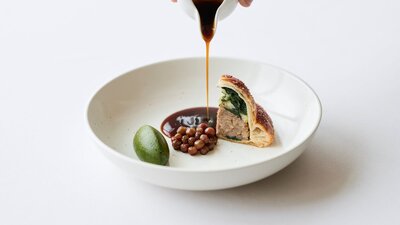 Sauce being poured over a meal.