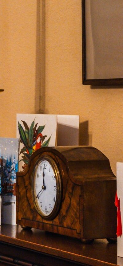 Calthorpes House mantlepiece with small clock and Christmas cards