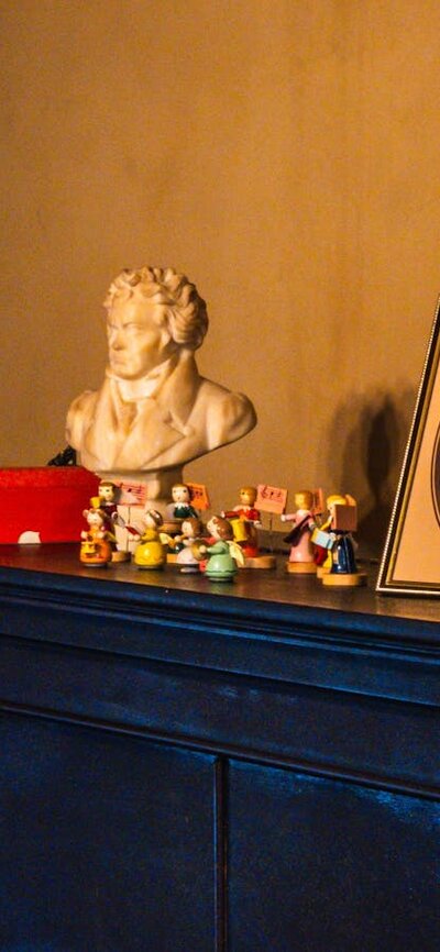 Calthorpes House mantlepiece with image of Dawn Calthorpe, small sculptures and Christmas ornaments