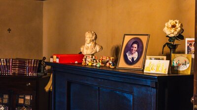 Calthorpes House mantlepiece with image of Dawn Calthorpe, small sculptures and Christmas ornaments