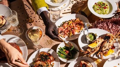 Platters of food spread out on beige table