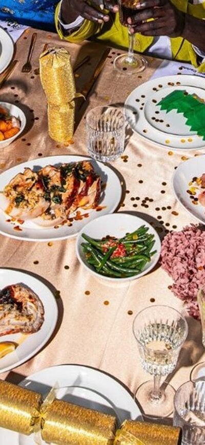 Platters of food and drink glasses spread out on beige table