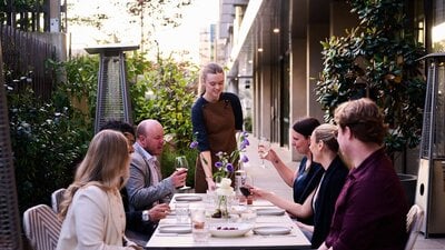 An image of a group of people eating dinner together at a restaurant in Canberra.