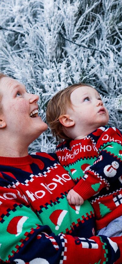 Snowy Christmas trees Women with baby admiring white Christmas trees