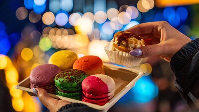 Macarons Set of 6 colourful macarons with Christmas lights in the background