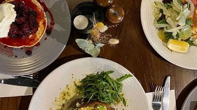 Plates of food served on a wooden table at 1882 Hall