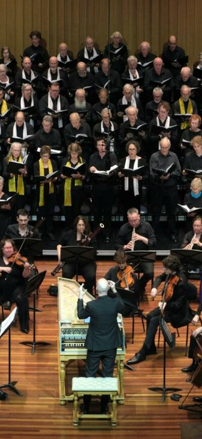 CCS A Handel Celebration 13 Dec 2025 Choristers performing on stage with orchestra, conducted from a harpsichord by Erin Helyard