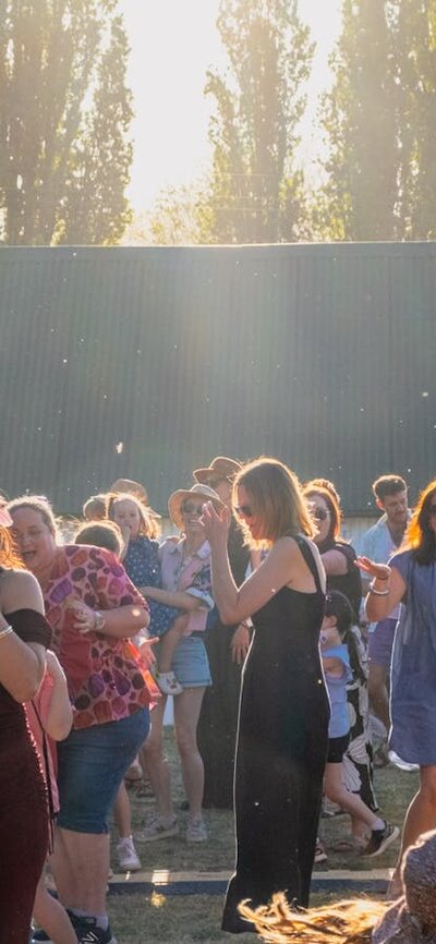 Kirrah Amosa singing at Lanyon Homestead as the audience dances around her