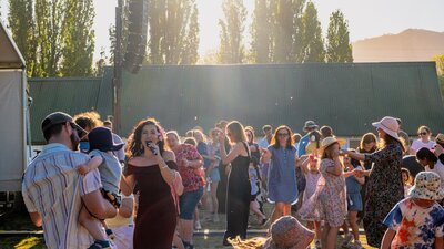 Kirrah Amosa singing at Lanyon Homestead as the audience dances around her
