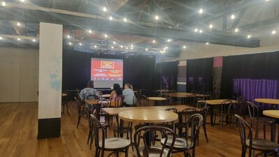 From our first Movie Screening Tables and chairs with the screen up on the stage