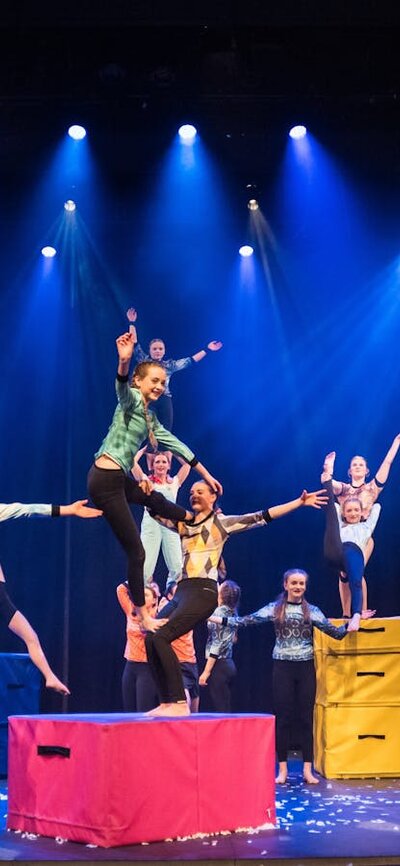 A group of young acrobats in a tableau of acrobatic forms