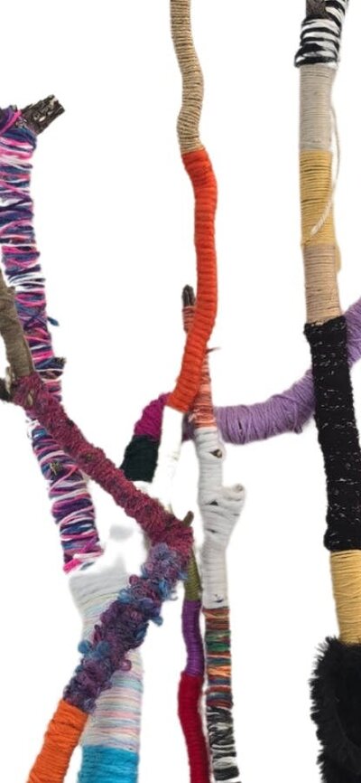 Branches of varying size have been wound in yarn in different colours and textures.