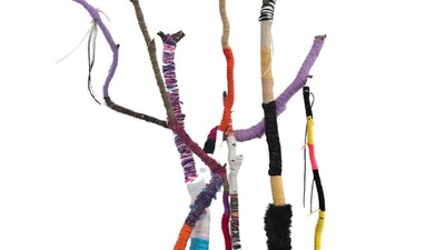 Branches of varying size have been wound in yarn in different colours and textures.