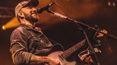 Cody Pennington playing guitar and singing