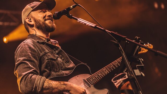 Cody Pennington playing guitar and singing