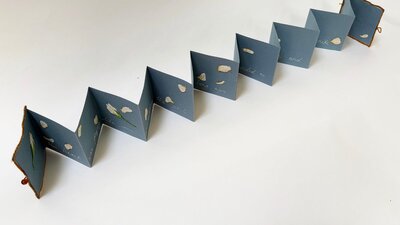Folded paper material with writing and floral illustrations