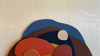 A collage of rounded abstract shapes suggesting a hilly, rocky landscape.