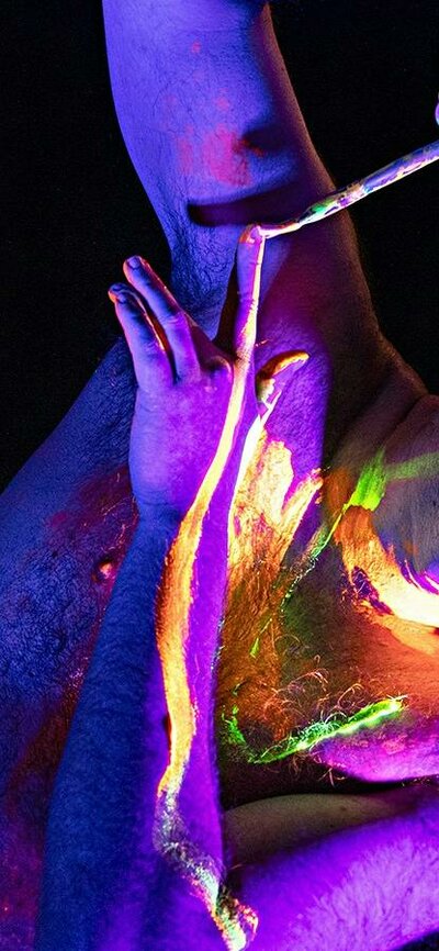 Creative Juices, Photo Kat Fogarty Man painting his arm with UV body paint
