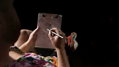 Creative Juices, Photo Kat Fogarty Person creating a figure drawing on a small notepad