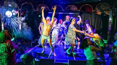 Audience dancing on stage under disco lights