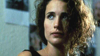 Woman with disheveled hair looking past the camera