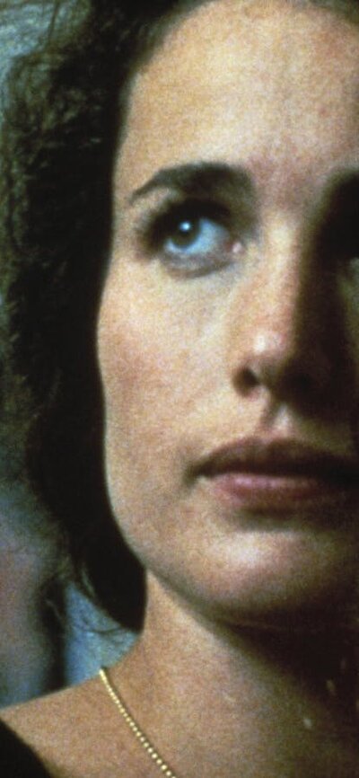 Woman with disheveled hair looking past the camera