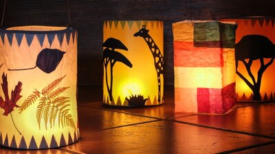 Colourful paper craft lanterns lit up with various nature and animal prints