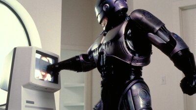 RoboCop: Directors Cut (1987) Robot pointing at screen