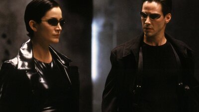 The Matrix (1999) Man and woman standing dressed in black wearing black sunglasses
