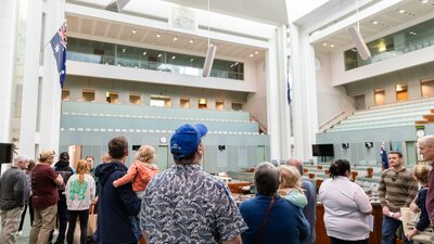 Visitors explore the House of Representatives Chamber at Parliament House.