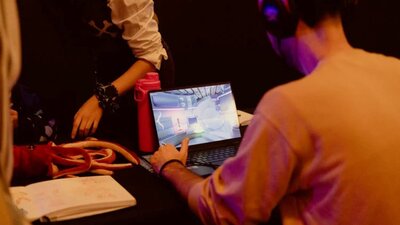 A man plays a game on a laptop computer