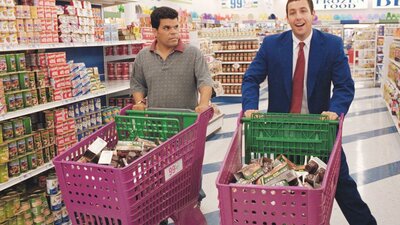 Two men in shopping centre with pink shopping trolleyrs