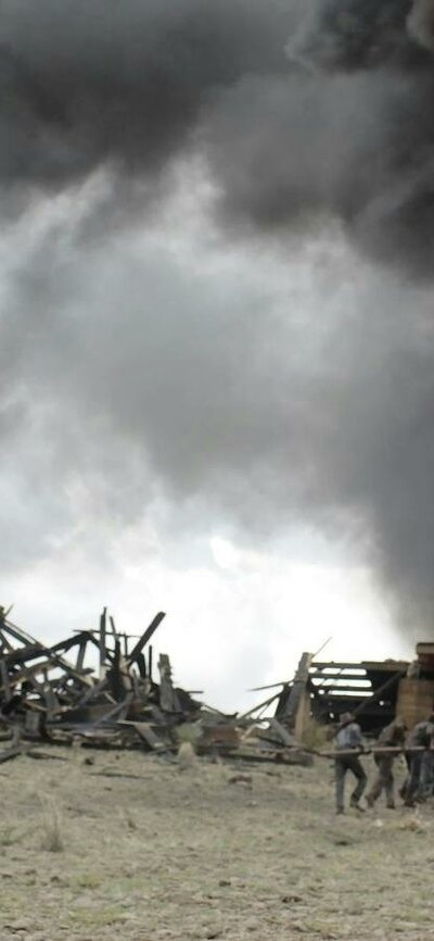 Man seated watching a firey explosion